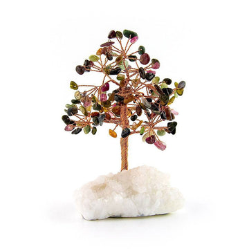Tourmaline copper tree rooted in white crystal base against white background for spiritual home decor.
